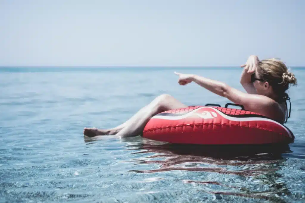 Woman floating in a tube on the ocean