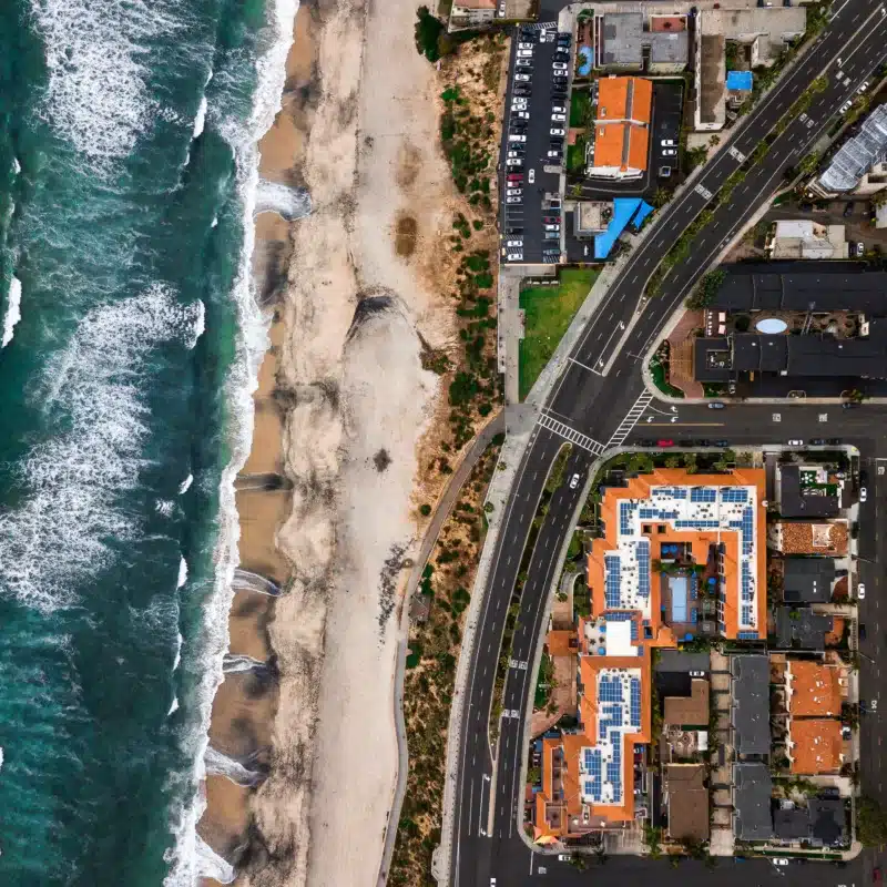 Aerial view of Carlsbad, California, showing the beach and some of the coastal homes.