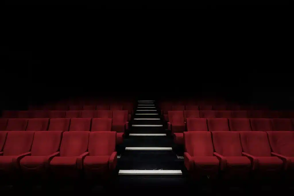Dark theater room with red seats