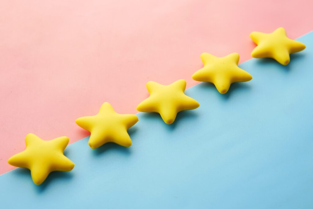 Vibrant Display: Yellow Stars Aligned on a Serene Blue and Pink Surface