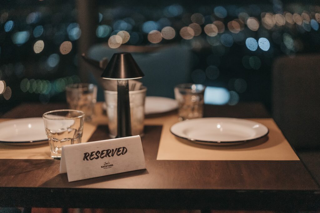 A fine dining restaurant table with a reserved sign