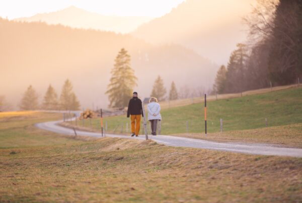 Two people walking down a trail