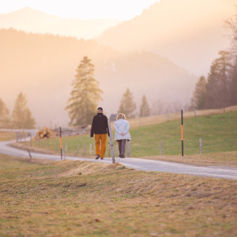 Two people walking down a trail